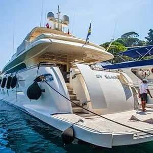 Eco-friendly marine cleaning products used on a yacht deck with cleaning supplies and ocean background